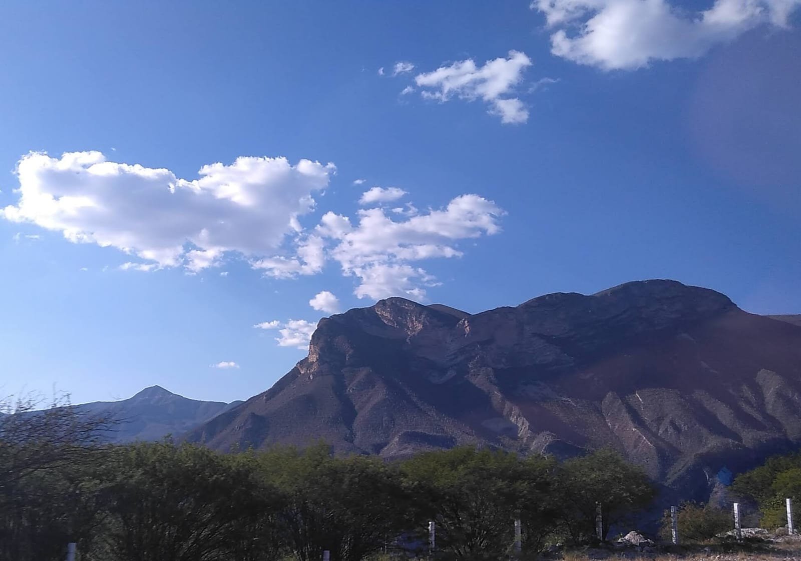 A dry, folded highland landscape of the Mixteca Alta in Oaxaca.