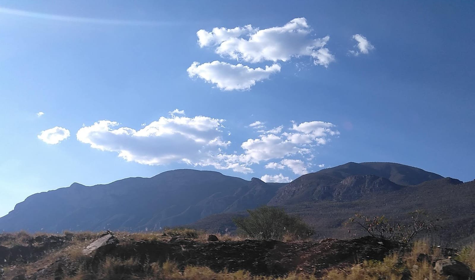 A green, folded mountain landscape of the Sierra Madre del Sur in Oaxaca.